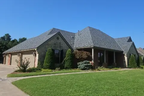 Residential home with designer shingles installed by Yates Roofing and Construction in OKC