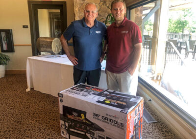 2023 Yates Roofing in OKC Golf Tournament: Closest to the Pin Winner standing with Curtis Yates
