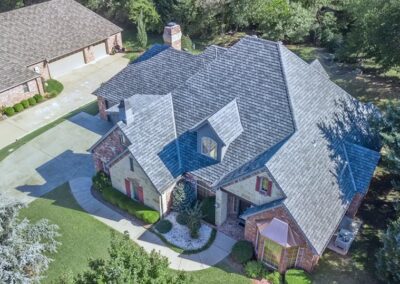 Residential home in the Oklahoma City area with Malarkey Legacy IR shingles in Natural Wood installed by Yates Roofing. GAF Camelot II shingles in Antique Slate