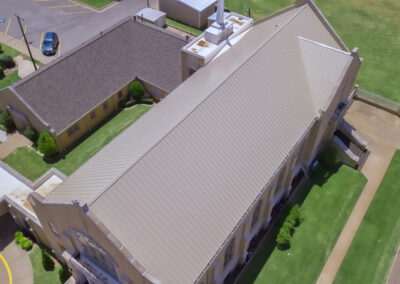 Arial view of First Christian Church in OKC showing Malarkey Highlander AR - Natural Wood and Metal Roof system installed by Yates Roofing in OKC.